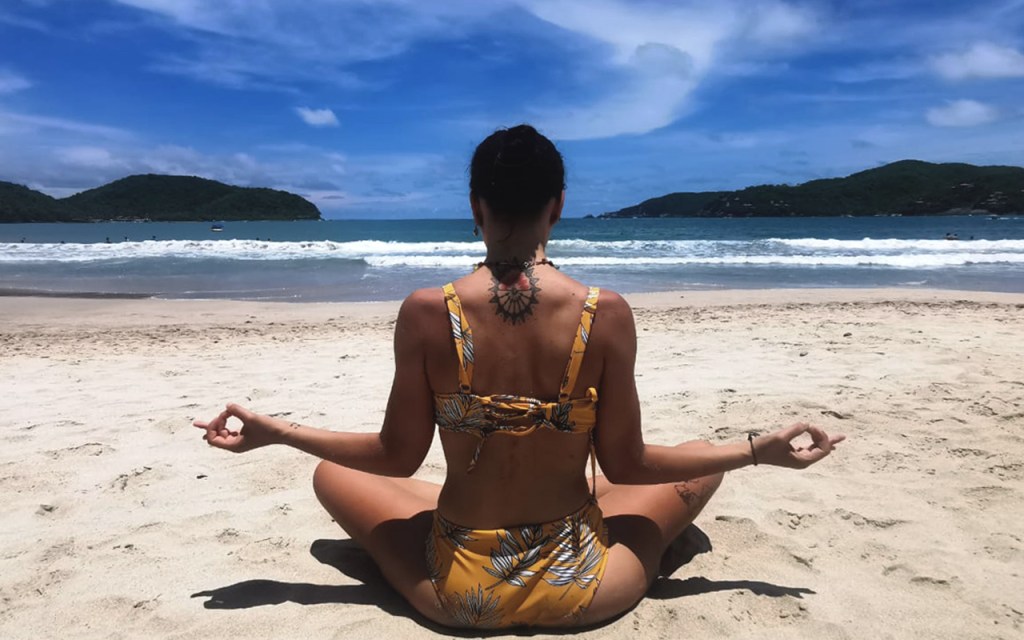 Girl doing yoga on a Mexican beach